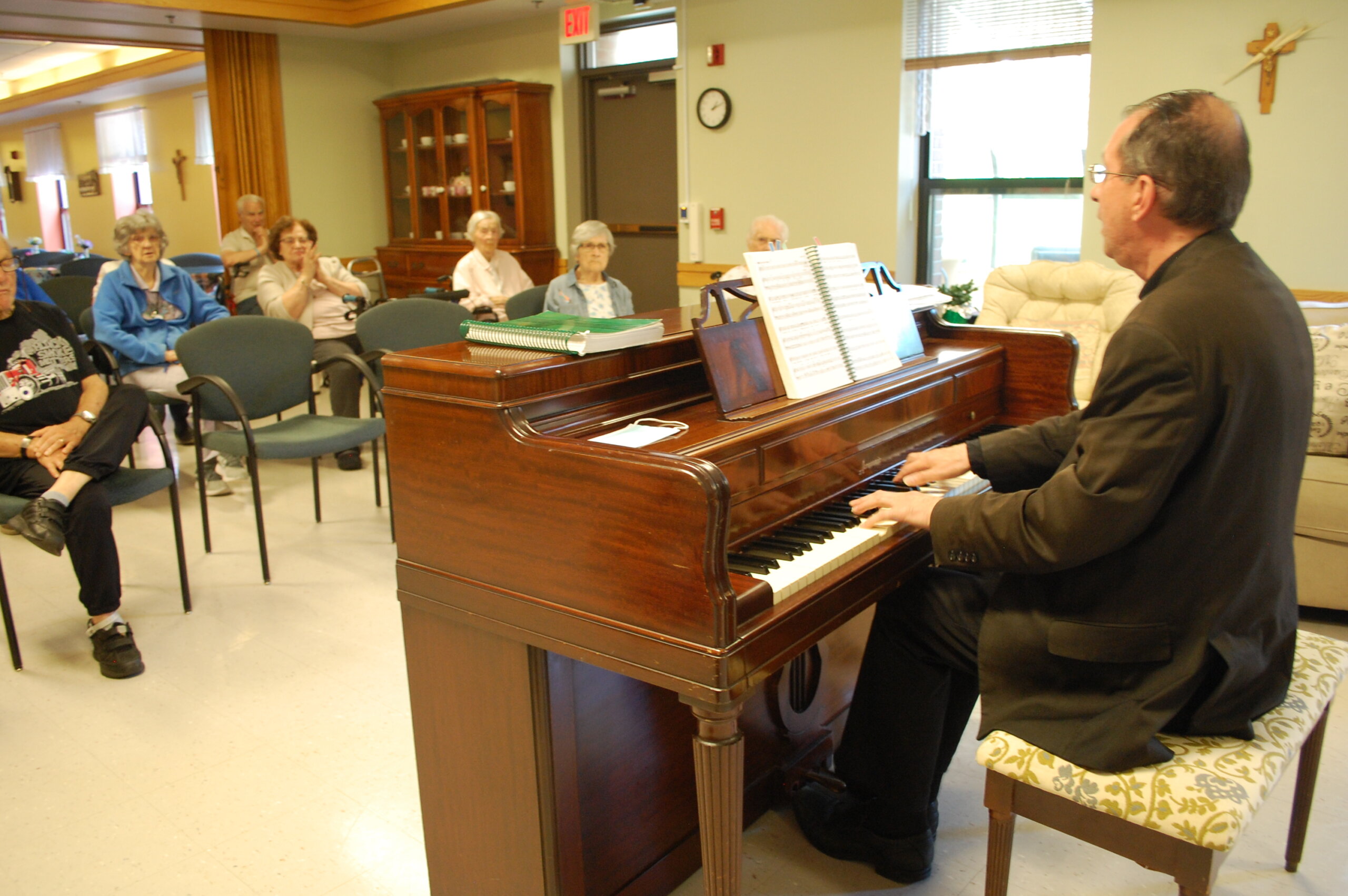 Father Harlow entertains residents of Winooski residential care